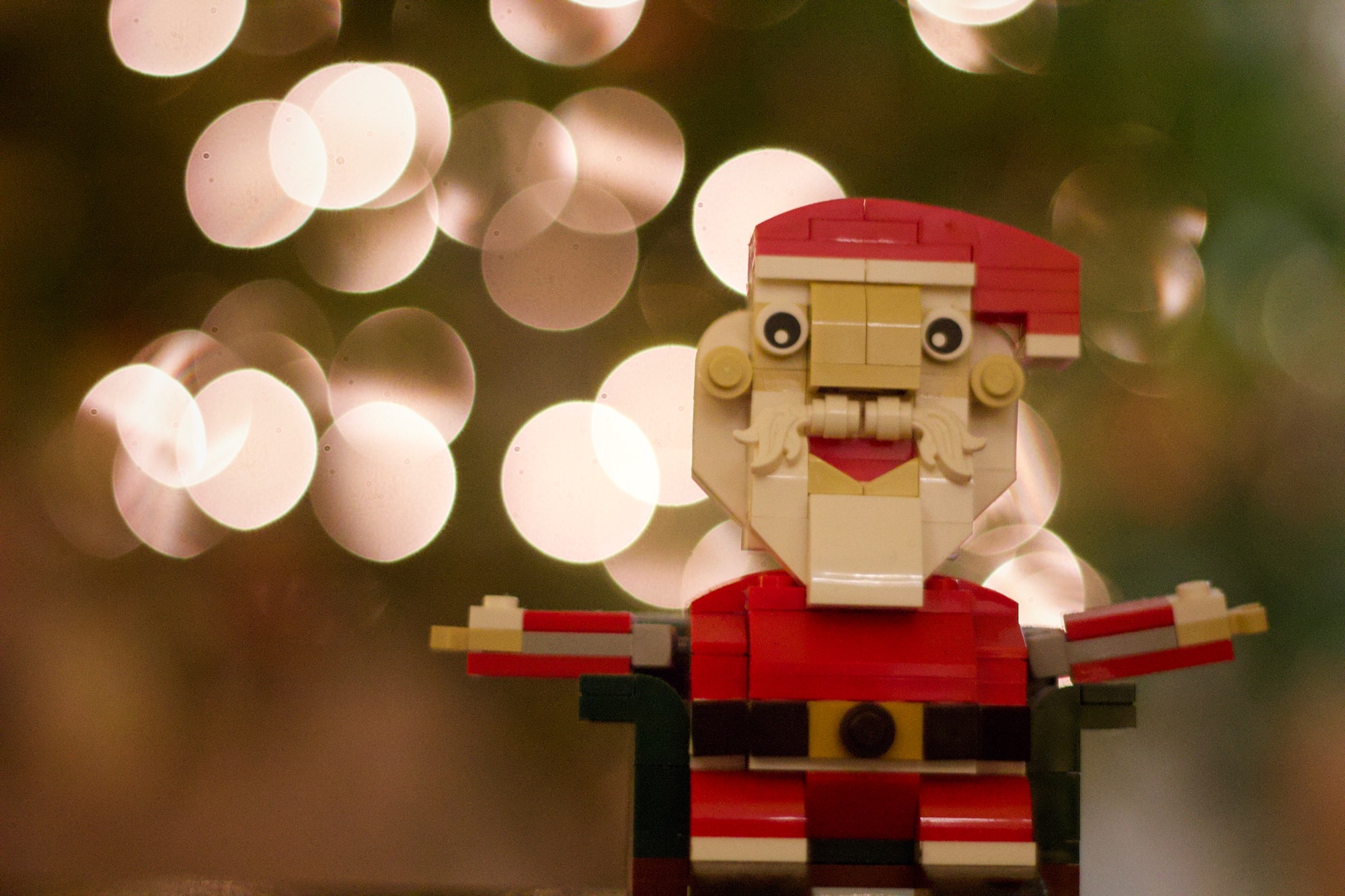 Lego santa with tree lights in the background